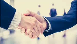 How do traders react when one company buys out another and what is likely to happen in terms of stock price?