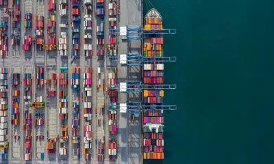 Aerial view cargo ship terminal, Unloading crane of cargo ship terminal, Aerial view industrial port with containers and container ship.