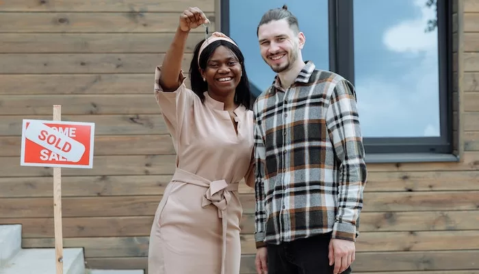 smiling woman holding a key